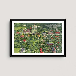 May include: An aerial view of the University of North Carolina campus in Chapel Hill, NC, framed in a black border. The image shows buildings, trees, and the text "CS - Air View, showing Center Section of Campus, University of North Carolina, Chapel Hill, N.C."