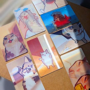 May include: A collection of eight rectangular cards featuring various illustrated cats and a dog, each measuring 85.6mm x 53.98mm. The cards display colorful, artistic depictions of animals in different poses, with some including the text miibrew.etsy.com.