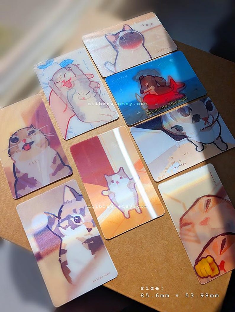 May include: A collection of eight rectangular cards featuring various illustrated cats and a dog, each measuring 85.6mm x 53.98mm. The cards display colorful, artistic depictions of animals in different poses, with some including the text miibrew.etsy.com.