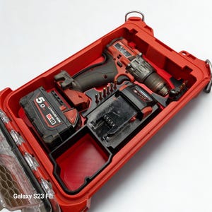 May include: Red power tool kit containing a red and black drill, battery, and drill bits. The kit is open, revealing the tools neatly organised within. The battery reads "5.0 REDLITHIUM-ION M18". The kit is in a red case.