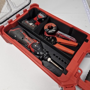 May include: A red plastic tool case with a clear lid containing a black molded insert. Inside are a red and black cordless rotary tool, a battery pack labeled 4.0, a spool of Powertech wire, a red utility knife, and orange-handled wire strippers.