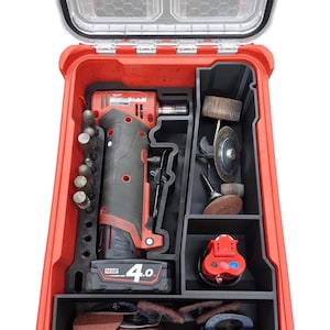 May include: Red tool case with a black foam insert. The case contains a red and black cordless rotary tool, a battery, and various attachments. The battery is labelled "M12 4.0".
