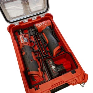 May include: A red and black power tool kit with a clear lid. The kit contains two power tools, a battery, and various bits. The tools are labelled "Milwaukee FUEL". The kit is designed for easy storage and transport.