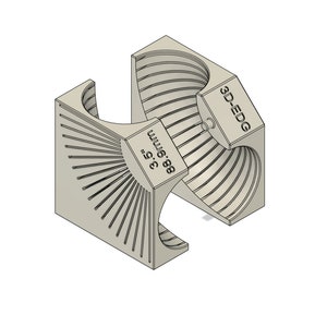 May include: A 3D printed, beige-colored, geometric shape with the text "3D-EDG" and "88.6 mm 3.5" printed on the side. The shape is made up of two interlocking pieces.