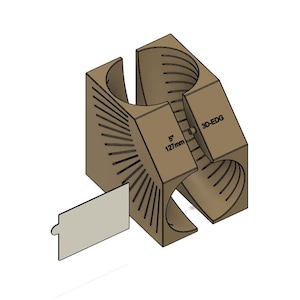 Op de afbeelding: Een beige 3D-EDG gereedschap met een 127mm (5 inch) maataanduiding, ontworpen met een centrale cilindrische uitsparing en stralende sleuven op de buitenkant, vergezeld van een klein, lichtgekleurd, rechthoekig bevestigingsonderdeel.