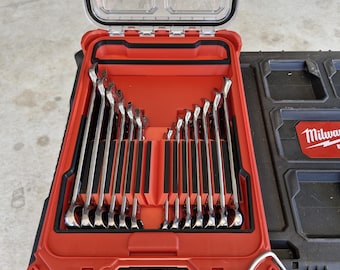May include: A red and black tool case with a clear lid, open to reveal a set of shiny, silver wrenches. The wrenches are neatly organized in a fitted interior. The case is part of a larger black tool storage system.