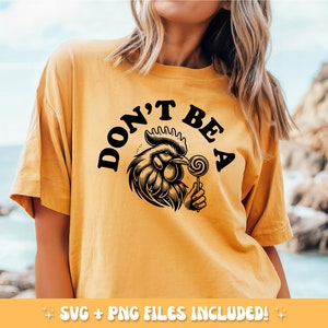 May include: Mustard yellow t-shirt with the text "DON'T BE A" above a detailed black and white illustration of a rooster holding a lollipop. The shirt includes SVG and PNG files.