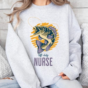 May include: Gray sweatshirt with a graphic of a fish on a hook with the text "Off-duty NURSE" printed below.