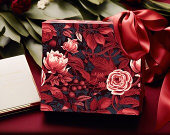 May include: A red gift box with a floral pattern featuring red, white, and green flowers. The box is tied with a red satin ribbon.