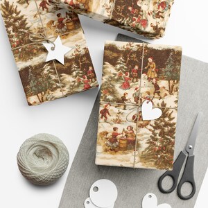 May include: Three gift boxes wrapped in vintage Christmas paper featuring a winter scene with children playing in the snow. The paper has a brown background with white snow and green trees. The boxes are tied with twine and decorated with white paper stars and hearts.