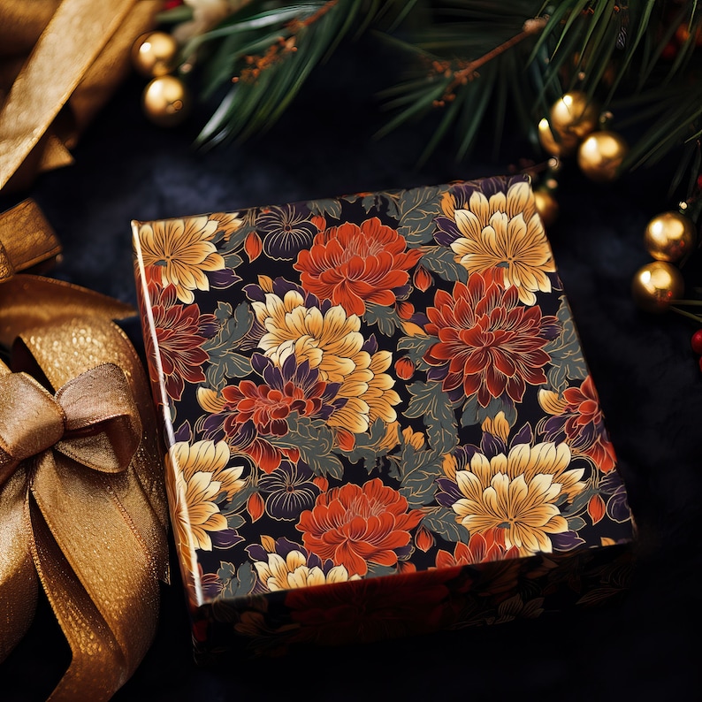May include: A black gift box with a floral pattern featuring red, orange, yellow, and white chrysanthemums. The box is wrapped in a dark background with gold accents.