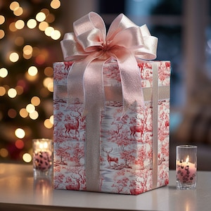 May include: A gift box wrapped in red and white patterned paper with a pink and gold bow. The paper features a repeating pattern of deer and trees. The box is sitting on a table with two candles.