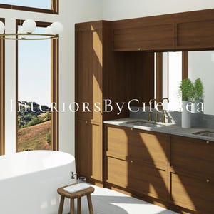 May include: A bathroom interior featuring a white freestanding bathtub, a wooden vanity with double sinks, brass faucets, and a tall cabinet. A round chandelier with white globe lights hangs above. The text InteriorsByChelsea is overlaid.
