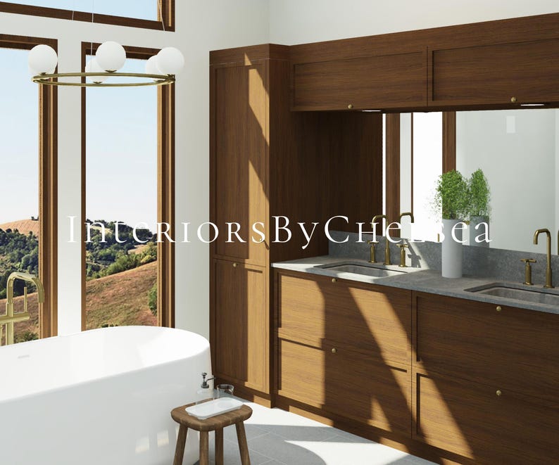May include: A bathroom interior featuring a white freestanding bathtub, a wooden vanity with double sinks, brass faucets, and a tall cabinet. A round chandelier with white globe lights hangs above. The text InteriorsByChelsea is overlaid.