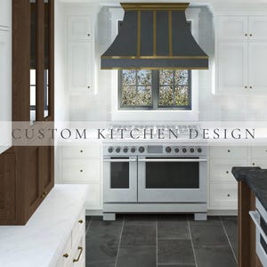 May include: A kitchen interior featuring white cabinetry, dark wood accents, and a large stainless steel range with a dark grey and gold metal range hood. The text CUSTOM KITCHEN DESIGN is overlaid across the centre of the image above the stove.