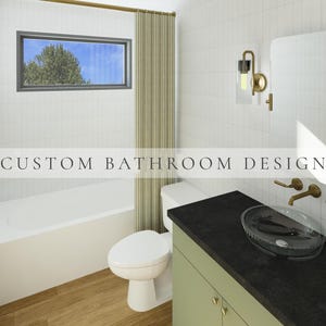 May include: A bathroom interior featuring white tiled walls, a white bathtub, a white toilet, and a sage green vanity cabinet with a black countertop. A glass vessel sink, gold faucet, and gold wall sconce are present. Text reads CUSTOM BATHROOM DESIGN.