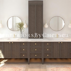 May include: A modern bathroom vanity with a white marble countertop and dark wood cabinets. The vanity has two round mirrors, two white pendant lights, and gold hardware. The text "Interiors By Chelsea" is visible on the countertop.