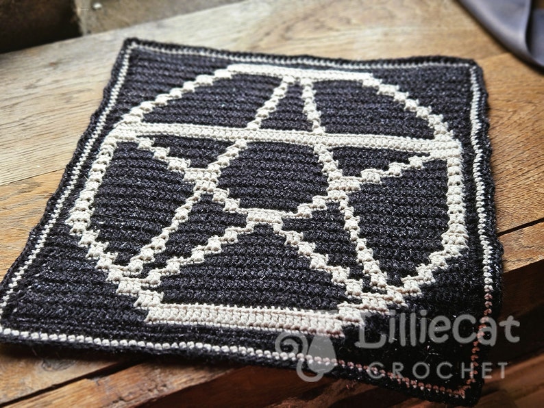 A crochet pattern using overlay mosaic crochet technique. The pattern has a dark background with a white pentagram motif in the middle. The watermark says Lilliecat crochet. It has an alternative and witchy feel.