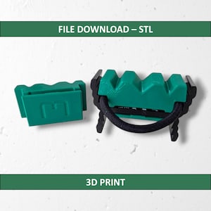 May include: Two 3D-printed green and black hair tie holders. One is a rectangular block with the letter "E" cut out. The other is a larger holder with a black elastic band. The text "FILE DOWNLOAD - STL" and "3D PRINT" are displayed.