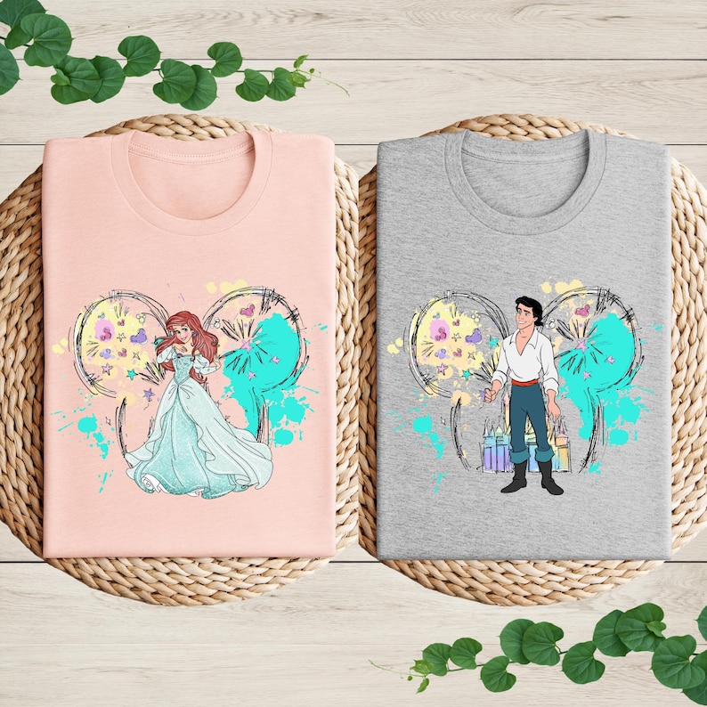 a couple of t - shirts sitting on top of a table