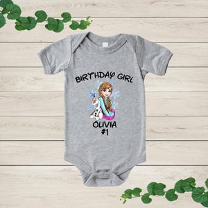 a baby bodysuit with a picture of a girl on it
