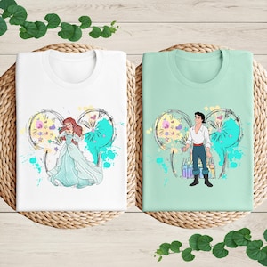 a couple of t - shirts sitting on top of a table