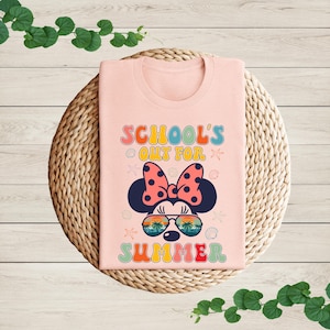 a pink shirt with a minnie mouse design on it
