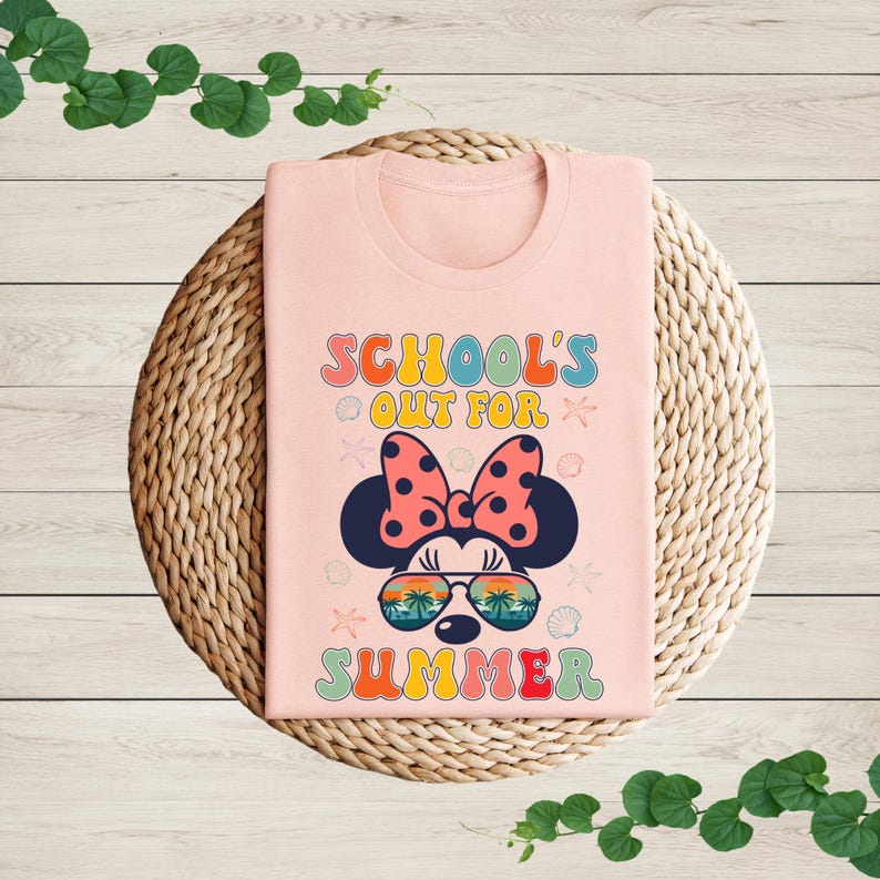 a pink shirt with a minnie mouse design on it