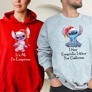 Two people wearing matching t-shirts with a cartoon character and text.