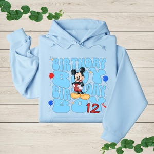 a blue hoodie with a mickey mouse on it