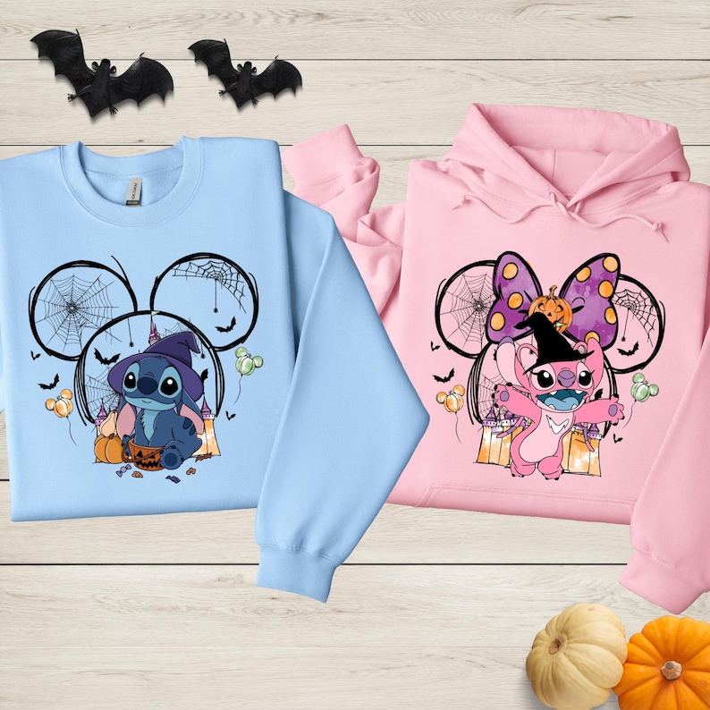 two colorful sweatshirts with illustrations of Lilo and Stitch from the Disney movie Lilo & Stitch, along with Halloween-themed decorations such as bats and pumpkins.