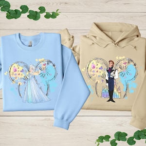 a couple of sweatshirts sitting on top of a wooden table
