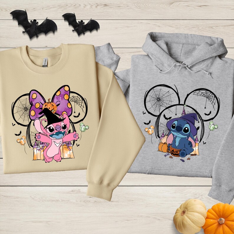 two t-shirts with Halloween-themed designs, including characters from the Disney movie Lilo & Stitch. The t-shirts are displayed on a wooden surface, along with bats and pumpkins, creating a festive Halloween atmosphere.