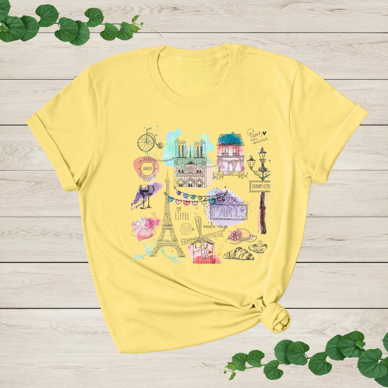a yellow t - shirt with a picture of the eiffel tower
