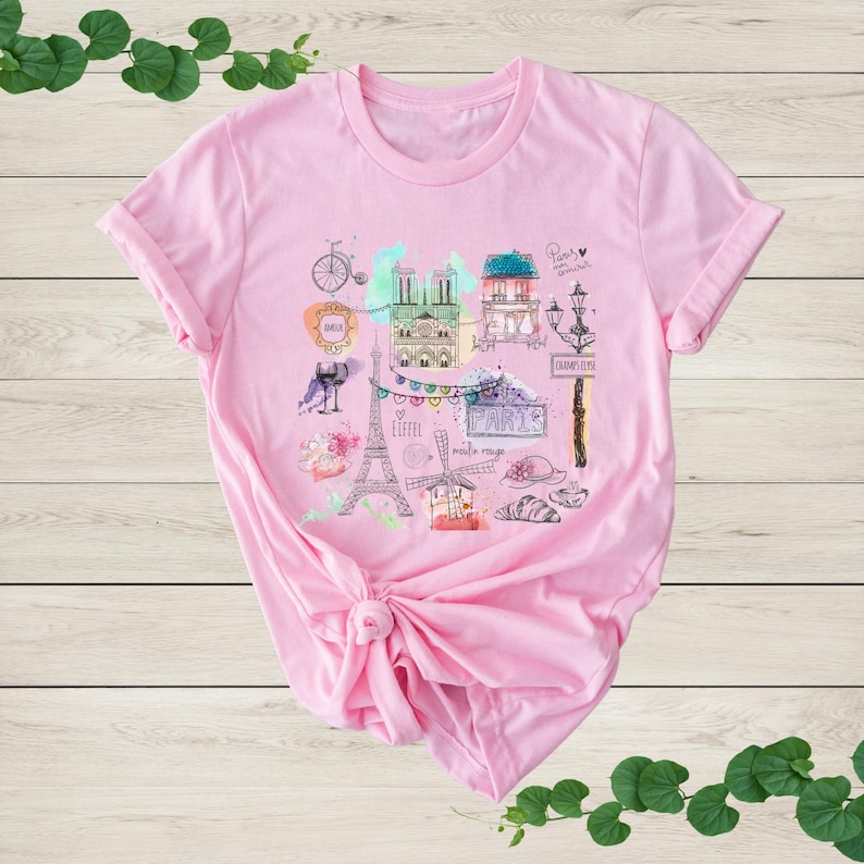 a pink t - shirt with a picture of the eiffel tower