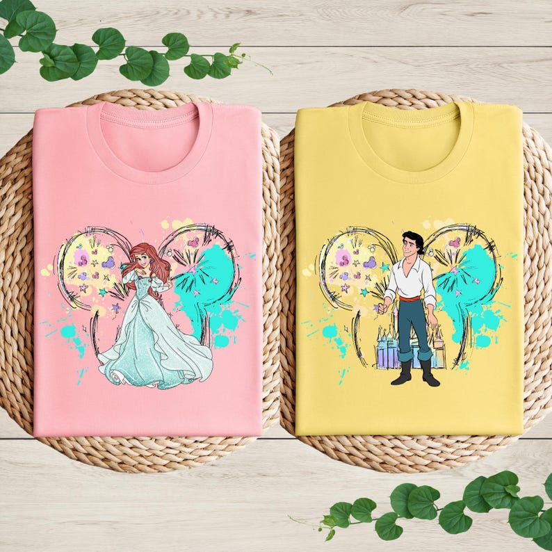 a couple of t - shirts sitting on top of a table