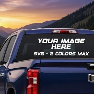 May include: A blue truck rear window with white text that reads "YOUR IMAGE HERE" and "SVG - 2 COLORS MAX". The background shows a sunset over a mountain range.