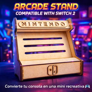 May include: A wooden arcade stand with the text "ARCADE STAND COMPATIBLE WITH SWITCH 2" in a colorful font. The stand has the word "NINTENDO" on top and a Switch console design on the front. The bottom text reads "Convierte tu consola en una mini recreativa".
