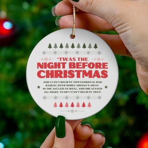 May include: White ceramic Christmas ornament with a red and black design. The ornament features the text 'Twas the Night Before Christmas' and a humorous Christmas-themed poem.