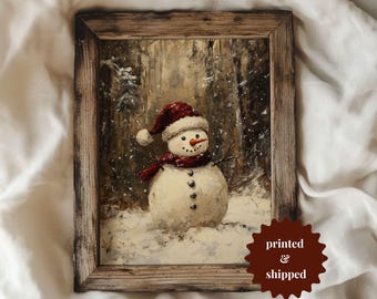 May include: A painting of a snowman wearing a red hat and scarf in a snowy forest setting.