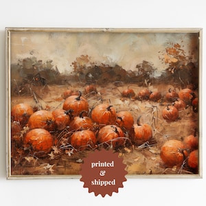 May include: A framed painting depicting a field of pumpkins in various shades of orange. The pumpkins are scattered across the field, with some in the foreground and others in the background. The painting is set against a backdrop of a hazy, autumnal landscape.