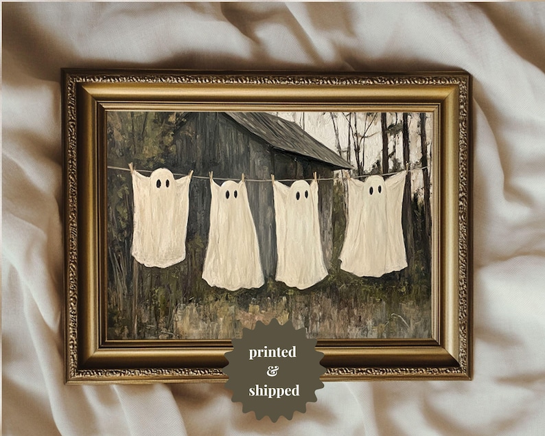 May include: A painting of four white ghosts hanging on a clothesline in front of a rustic wooden building. The ghosts have two eyes and are painted in a realistic style.