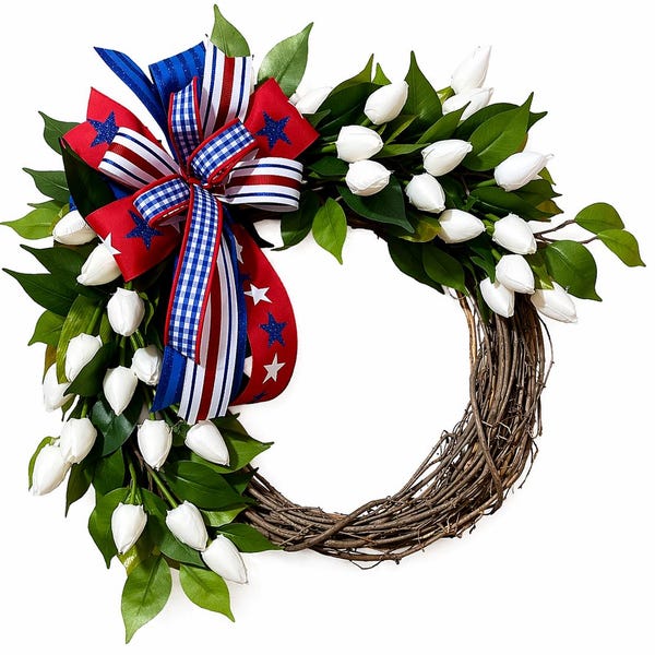 May include: A decorative wreath featuring white tulips, green leaves, and a patriotic bow. The bow is red, white, and blue with star and stripe patterns. The wreath's base is made of interwoven brown twigs, creating a natural, festive look.