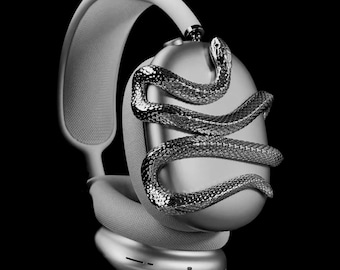 Può includere: Cuffie argentate con un designo a forma di serpente sull'auricolare. Le cuffie sono bianche e hanno un'archetto imbottito.