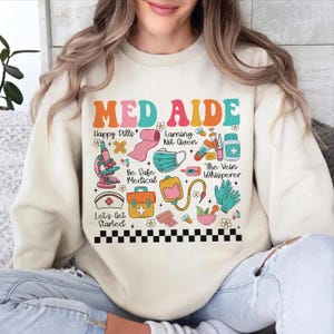 Med Aide Stuff Sweatshirt, Certified Medication Aide Shirt, Nurse Gift, Medical Assistant Shirt, Retro Groovy Floral Shirt, CMA Shirt