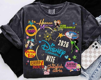 May include: Dark gray t-shirt featuring colorful graphics of Disney Channel shows like Hannah Montana, Kim Possible, and Lizzie McGuire. The shirt includes the text "Disney Channel Nite" and the year "2026".