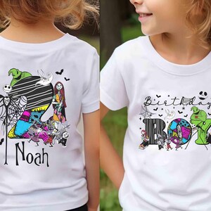May include: White t-shirts featuring colorful graphics from The Nightmare Before Christmas. One shirt has the name "Noah" with characters like Jack Skellington and Sally. The other says "Birthday Boy" with similar characters.