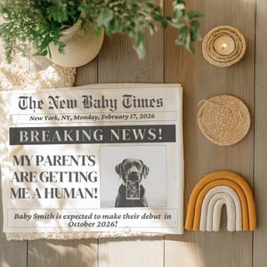 May include: A newspaper-style announcement titled "The New Baby Times" with the headline "BREAKING NEWS!". The announcement includes a photo of a dog holding an ultrasound image, and the text "MY PARENTS ARE GETTING ME A HUMAN!" and "Baby Smith is expected to make their debut in October 2026!"