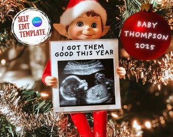 May include: A red and white elf doll holding a white frame with a black and white ultrasound image and the text "I got them good this year". A red ornament with the text "Baby Thompson 2025" is hanging on a Christmas tree.