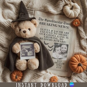 May include: A beige teddy bear wearing a dark gray witch hat and cape, holding an ultrasound photo. A newspaper with the headline "The Spooktacular Times BREAKING NEWS!" and pumpkins surround the bear. The text on the newspaper reads "OLIVIA & JACOB ARE EXCITED TO SHARE: OUR GHOUL GANG IS GROWING, SO READERS BEWARE!" and "BABY ANDERSON APRIL 2026".